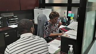 ATC Staff helps student register.  